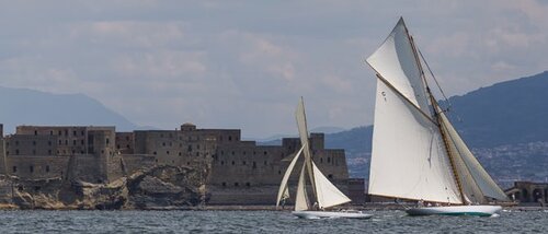 Classic yachts sailing across the harbour of Naples in the Vele d'Epoca